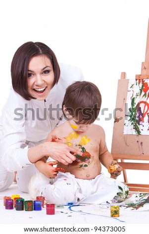 Joking happy smiling mother painting with son