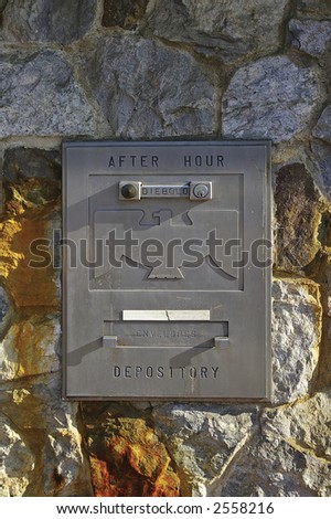 Night deposit box on weathered stone wall