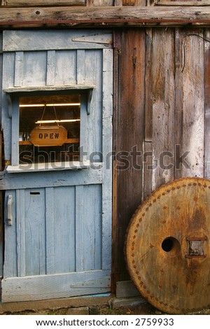 Rustic wooden barn door with rusty metal handles and \