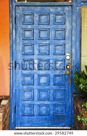 Classic spanish style painted blue wooden door with metal handle