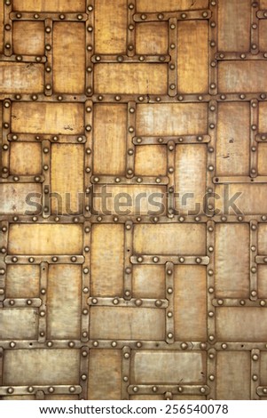 Closer view of riveted, metal plated, wooden door at Maharaj Sawai Mansingh II Museum, City Palace, Jaipur, Rajasthan, India, Asia