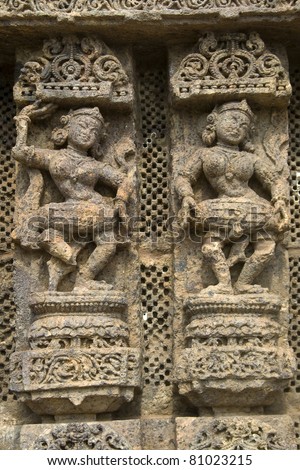 Exquisitely carved wall panel depicting ladies dancing and also beating the drum at Sun Temple, Konark, Orissa, India, Asia