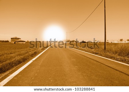 sun at horizon at the end of the road