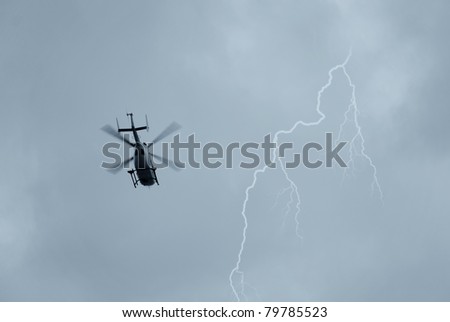 helicopter in the cloudy sky with lightning