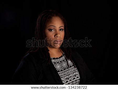 Beautiful plus size black woman on a dark background