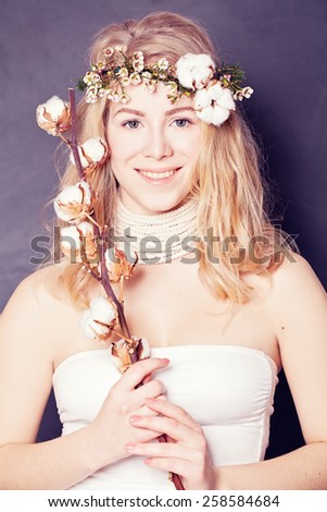 Beautiful lady with cotton flower in her hand