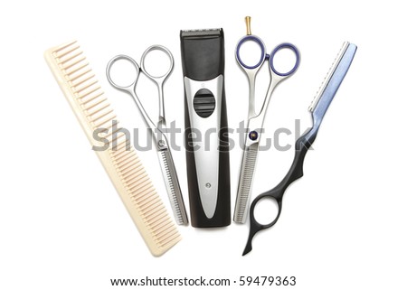 Hairdressing industry. Professional hairdressing tools. Comb, scissor, clippers and hair trimmer isolated on white background