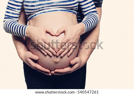https://image.shutterstock.com/display_pic_with_logo/533977/540547261/stock-photo-pregnant-belly-with-heart-symbol-man-hugging-pregnant-woman-and-woman-holding-her-hands-in-a-heart-540547261.jpg