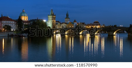 Prague, Evening panorama of the Charles Bridge with Old Town bridge tower and Dome of the church of Saint Francis of Assisi, Czech Republic