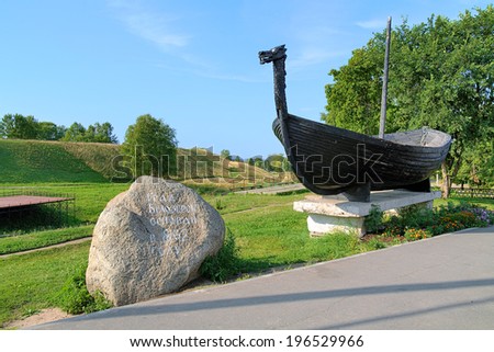 Memorial stone to commemorate the founding of the town Belozersk in 862 and Viking boat near the Belozersk Kremlin, Russia
