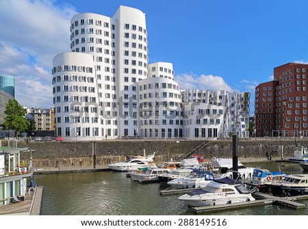DUSSELDORF, GERMANY - MAY 19, 2015: The buildings of Neuer Zollhof in the Media Harbor. The Neuer Zollhof buildings was designed by the famous American architect Frank O. Gehry and completed in 1998.