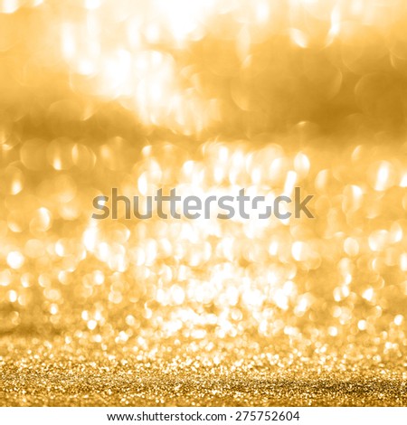 Festive abstract background with shiny gold sparkle effect