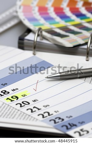Check-mark on calendar with pen