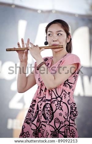 LUCCA, ITALY - OCTOBER 31: Michiko Yamada plays the classic Japanese flute with the AUN-J Classic Orchestra at the Lucca Comics and Games 2011 festival on Oct. 31, 2011 in Lucca, Italy.