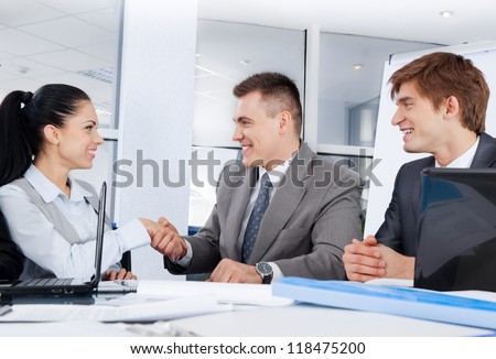 Business people handshake businesswoman businessman colleagues shake hand during meeting after signing agreement at desk in office