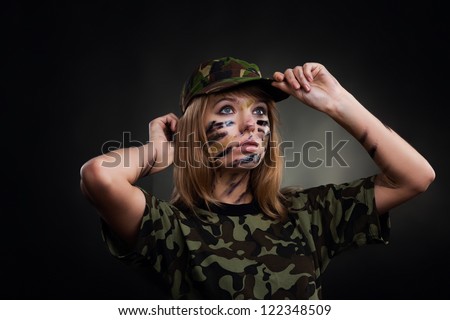 Beautiful army girl, soldier woman in t shirt military uniform over black background
