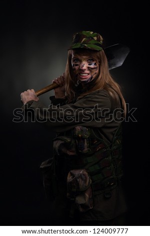 army girl attack shovel, soldier woman in a military uniform over black background