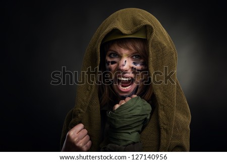 army girl frustrated scream attack, soldier woman cover by masking net military uniform over black background