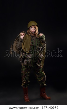 army girl, soldier woman in a military uniform full length over black background