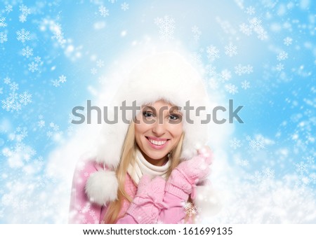 Christmas Girl. Winter new year woman, excited happy smile, wear warm fur hat scarf gloves over abstract christmas ornament with blowing snow flake blue background