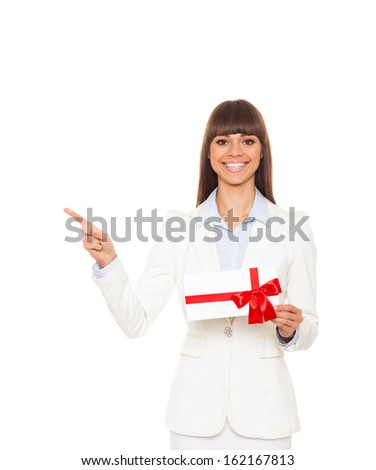 Business woman point finger side happy smile hold gift card present with red bow. Businesswoman show copy space isolated over white background