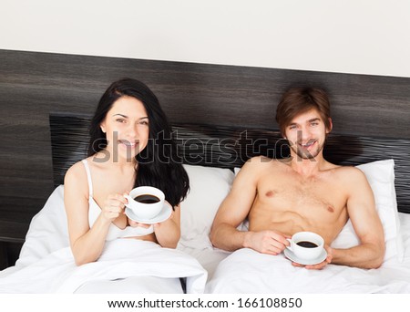 young couple drink coffee in bed, happy smile woman man lovers, love romantic valentine day morning concept, top angle view