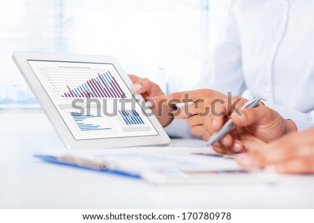 Businessman analyzing graph using digital tablet touch pad, touching hand point finger touch screen, business people group desk office, businesspeople report financial charts