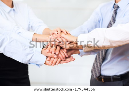 business people team putting their hands stack on top of each other, businesspeople colleagues pile of hand closeup, at office, concept of success collaboration leader