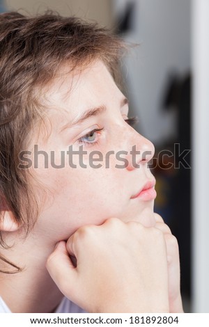 unhappy sad boy, face close up portrait stressed upset child at home, concept of teenage  stress and problems, depressed