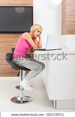upset woman using laptop at home unhappy negative emotion, sad girl problem surfing on computer