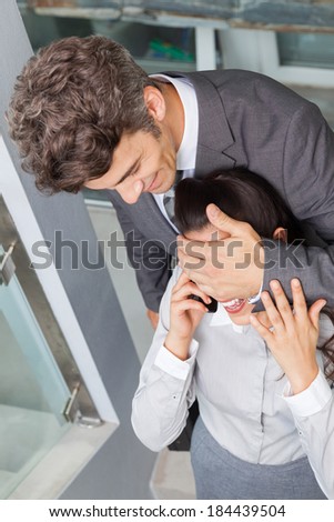 Businessman covering happy woman eyes at home, business man back home smile