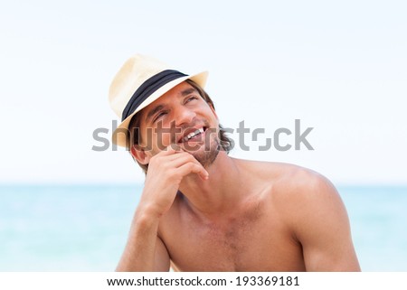 man smile on beach summer vacation, Handsome young male think look up to empty copy space, dream hold hand finger on chin wear hat, sun tanned body, guy over sea blue sky,