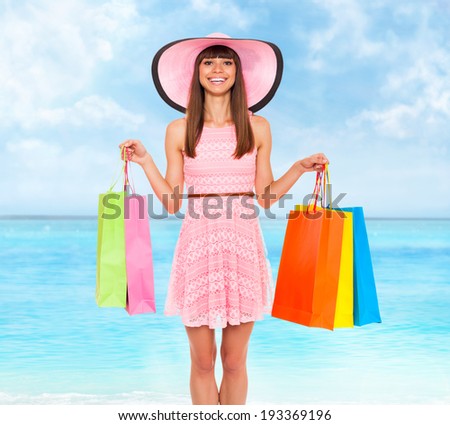 shopping woman summer vacation, hold colorful bags over blue sky ocean background, wear pink dress and hat happy smile, young girl shop tour
