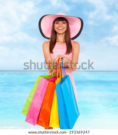 shopping woman summer vacation, hold colorful bags over blue sky ocean background, wear pink dress and hat happy smile, young girl shop tour