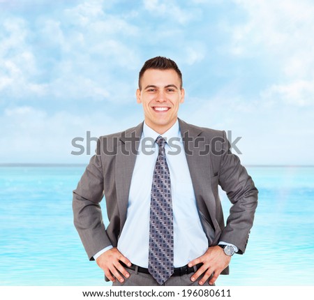 Handsome young business man happy smile summer ocean vacation, businessman with folded hands wear elegant gray suit and tie over sea blue sky