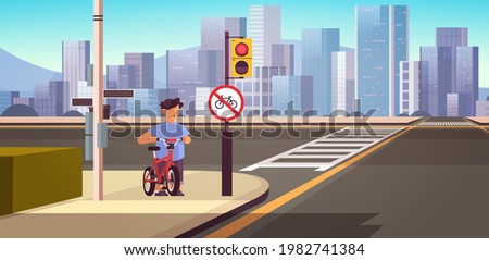 schoolboy with bicycle standing near red round kike ban sign road safety concept horizontal cityscape background