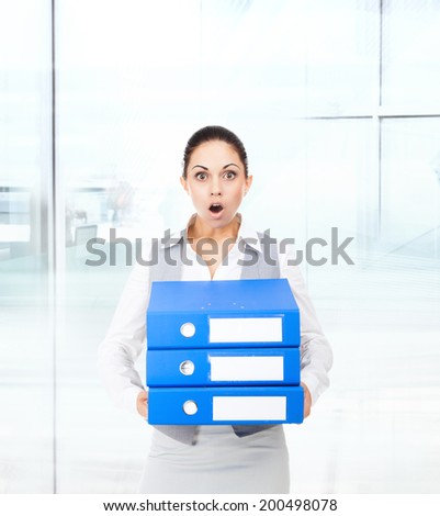 Businesswoman surprised scared, terrified hold stack folder, mouth open, young business woman concept of worried, shock lot of work in modern office