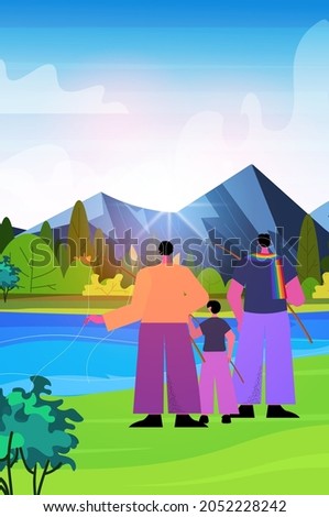 male parents fishing with little son gay family transgender love LGBT community concept landscape background