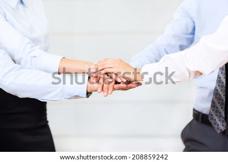 business people team putting their hands stack on top of each other, businesspeople colleagues pile of hand closeup, at office, concept of success collaboration leader