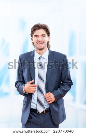 young business man smile in bright blue office, businessman executive wear suit