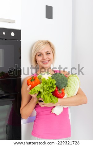 young woman hold raw fresh vegetables refrigerator, diet healthy organic vitamin food concept, pretty girl smile at home modern kitchen