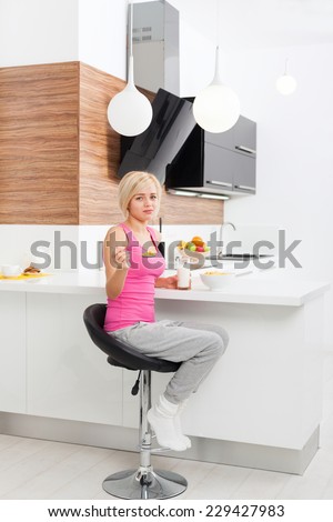 girl unhappy diet eating healthy cornflakes milk, young woman sad negative emotion, sitting at table modern kitchen home