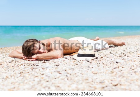 man sleep rest on beach, handsome male sleeping summer vacation, sun tanned body, guy over sea blue sky, ocean holiday travel