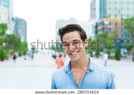 Handsome man face smile outdoor city street, Young attractive businessman casual blue shirt