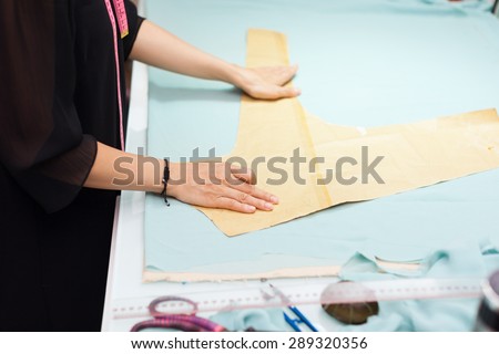 Asian woman tailor fashion clothes dress designer working with fabric on table