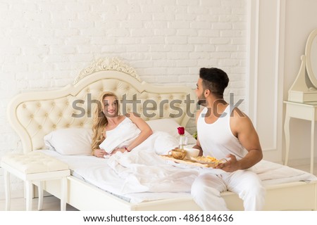https://image.shutterstock.com/display_pic_with_logo/534712/486184636/stock-photo-hispanic-man-bring-breakfast-to-woman-in-morning-tray-with-red-rose-flower-young-couple-lovers-in-486184636.jpg