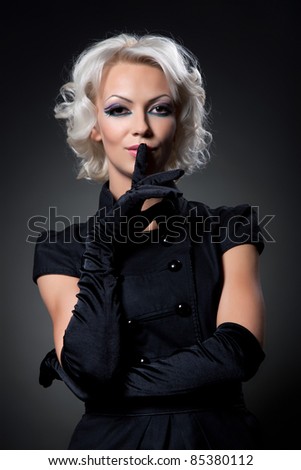Portrait of a beautiful attractive woman with make up and hair style over black background, series of photos