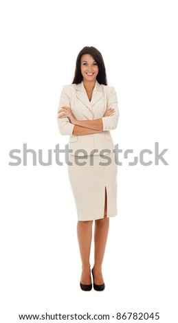 Full length portrait of a happy business woman standing with folded hands in modern suit isolated over white background