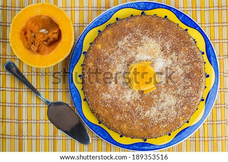 Homemade coconut and pumpkin cake on a yellow tablecloth
