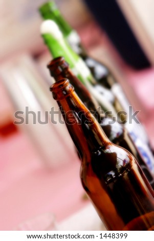 Line of Beer Bottles at a Party, Reception, or Holiday Event (shallow focus, color saturated).